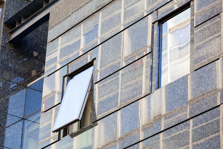 Modern building exterior with glass and metallic facadeの写真素材