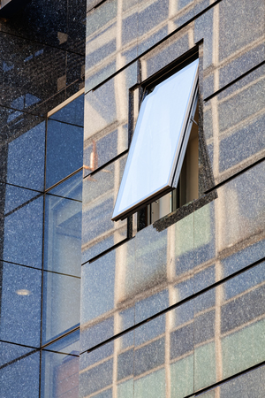 Modern building exterior with glass and metallic facadeの写真素材