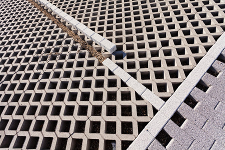 parking places of hollow concrete slabs with a sidewalk around