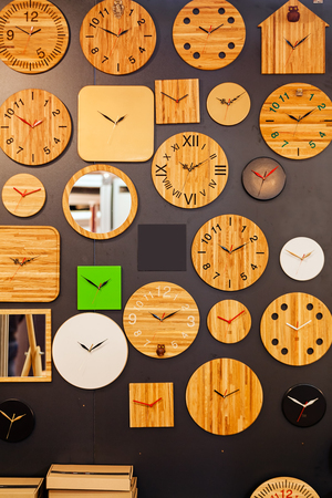clocks made of wood on the wallの写真素材