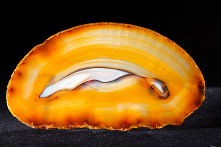 Orange agate mineral isolated on the black backgroundの写真素材