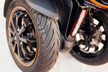 Photo of three wheel scooter back wheel; note shallow depth of field