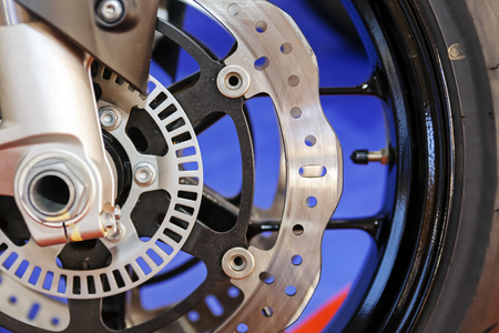 Photo of closeup motorcycle wheel steel mechanism; note shallow depth of fieldの写真素材