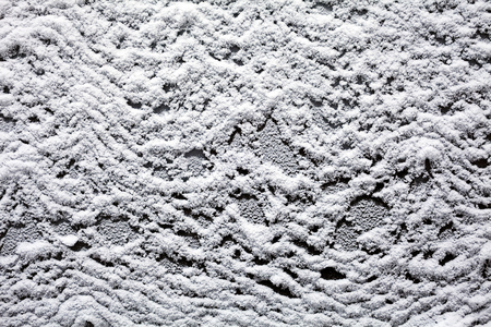 Snow cover silver car hood after snowの写真素材