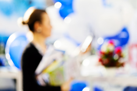 Blur image of a woman with balloons at technology expo; blurred 100%の写真素材