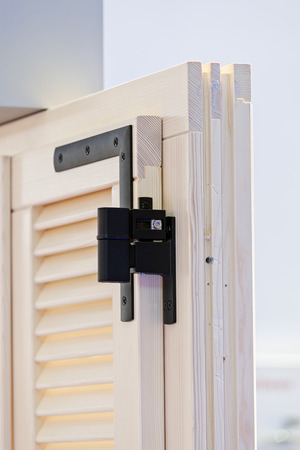 Wooden blind for window with mechanism for opening; note shallow depth of fieldの写真素材