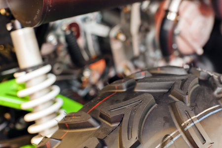 Closeup motorcycle wheel tyre with background; note shallow depth of fieldの写真素材