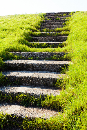 Old stone stairs in grass field, leading upの写真素材