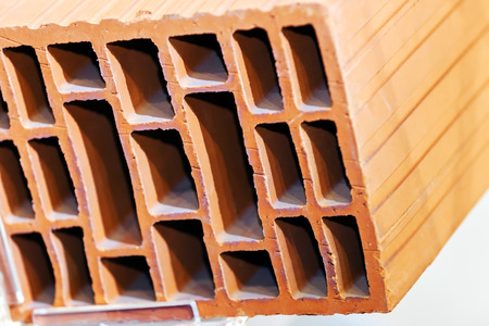 Detail of orange hollow clay block on a stand at construction fairの写真素材