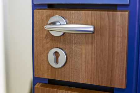 Metal door handle mechanism on exhibition wooden wallの写真素材