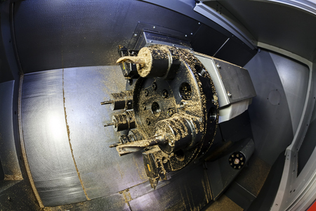 Industrial lathe tool and lathe machine in progress; note shallow depth of fieldの写真素材