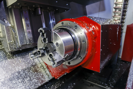 Industrial lathe tool and part of the lathe machine; note shallow depth of fieldの写真素材