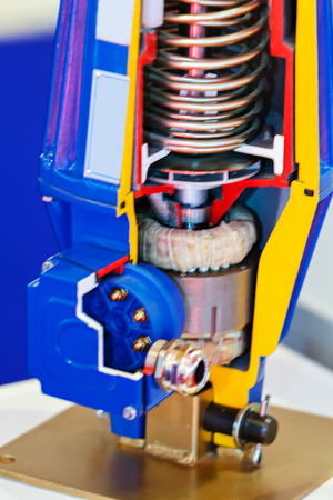 Cross section of fabric engine part with helical spring; note shallow depth of fieldの写真素材