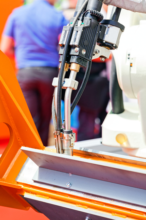 Robotic cutting machine tool for industrial manufacture factory; note shallow depth of fieldの写真素材