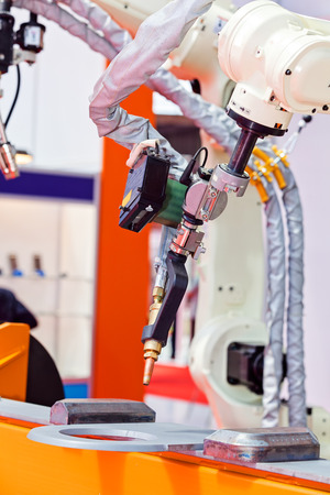 Robotic cutting machine tool for industrial manufacture factory; note shallow depth of fieldの写真素材