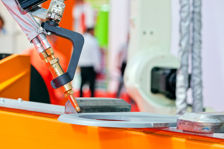 Robotic cutting machinel for industrial manufacture factory; note shallow depth of fieldの写真素材