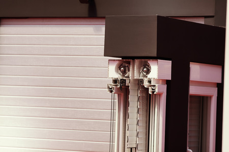 lateral cross-section aluminum frame windows with  mehanism for shutters, note shallow depth of fieldの写真素材