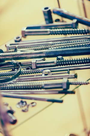 screws, nuts, clamps ...on the glass, note shallow depth of fieldの写真素材