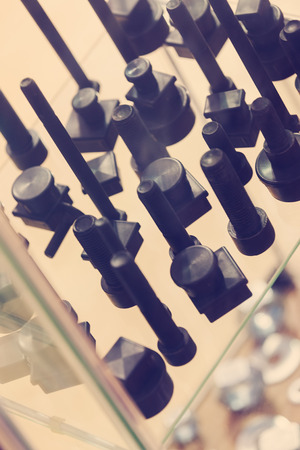 screws, nuts, clamps ...on the glass, note shallow depth of fieldの写真素材