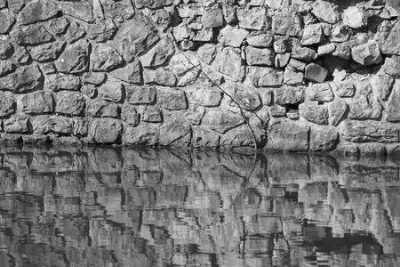 wall of stone above water, note shallow depth of fieldの写真素材