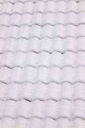 Roof of the house covered with snowの写真素材