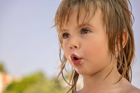 face of a little girl dirty with ice creamの写真素材
