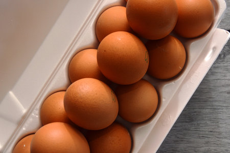 A chicken egg lies in a shipping box and is sold at the supermarket. decorative egg