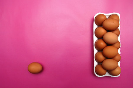 A chicken egg lies in a shipping box and is sold at the supermarket. decorative egg