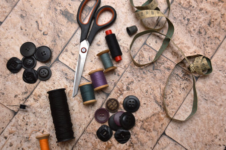 Still life of garments. Threads, needles, scissors, thimble, patterns