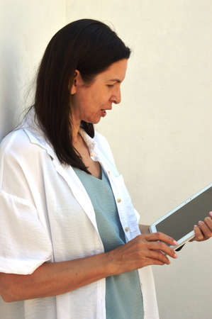 A girl with a smartphone browses the social pages of the siteの写真素材