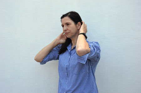 young girl in a plaid shirt shows hand gestures