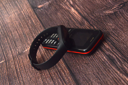 Fitness bracelet and phone on wooden backgroundの写真素材