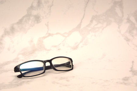 eyeglasses on white marble background with copy space for text.の写真素材