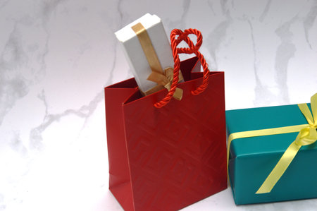 Gift boxes in red and green on a white marble background.