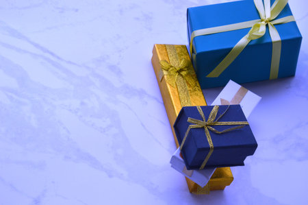 Gift boxes with yellow and blue ribbons on a white background