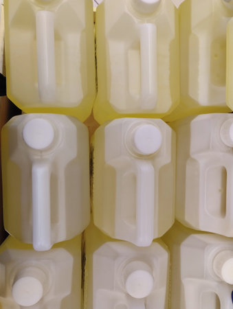 Plastic bottles of milk in a row, closeup of photo