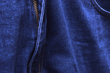 Blue jeans texture with seam closeup. Blue denim jeans background.の写真素材