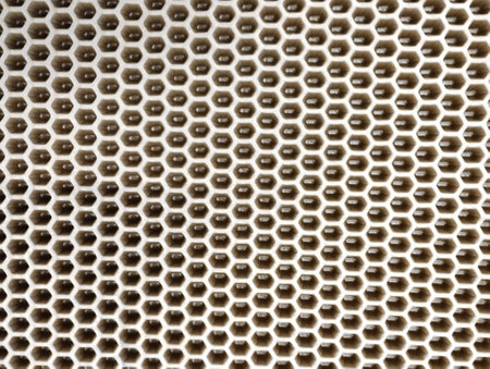 Abstract background of a metal mesh with holes in the form of honeycombsの写真素材