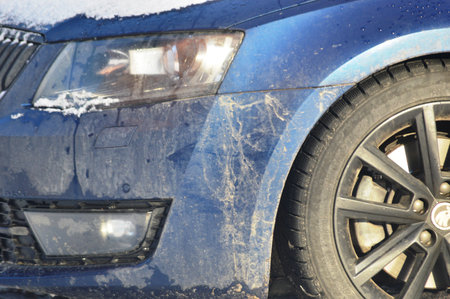 car in the snow, winter tires, closeup of photo with shallow depth of fieldの写真素材