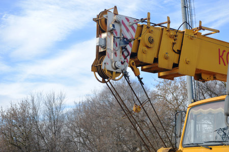 Crane on a construction site against blue sky, closeup of photoの写真素材