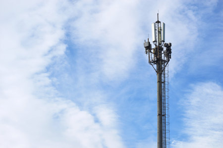 Telecommunication tower with blue sky and white cloud background, Technology concept