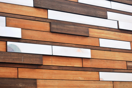 Wooden wall of a modern house with a pattern of different colorsの写真素材