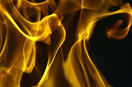 yellow fire flames on a black background. abstract background for design.の写真素材