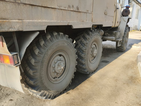 Wheel of a big off-road vehicle, closeup of photo