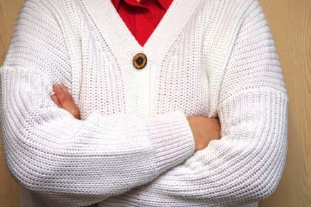 A closeup shot of a man wearing a white knitted sweaterの写真素材