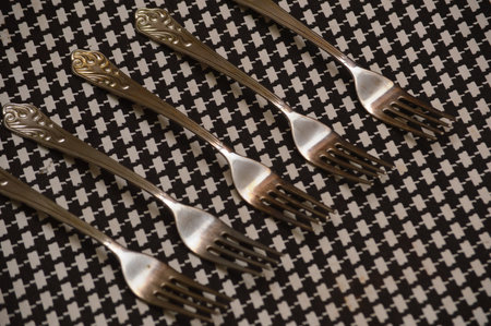 Vintage silverware on black and white checkered tableclothの写真素材