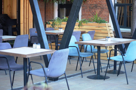 Tables and chairs in an outdoor cafe, closeup of photo
