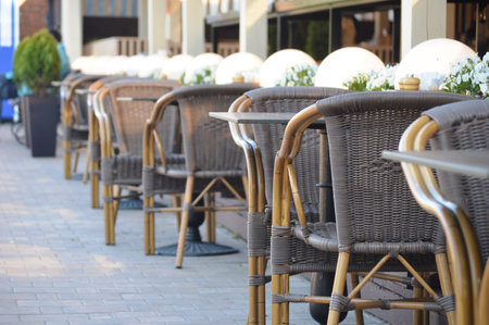 Outdoor terrace with tables and chairs in the city, selective focusの写真素材