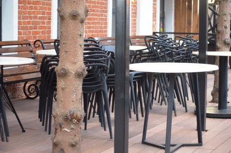 Tables and chairs in a cafe in the city, stock photo