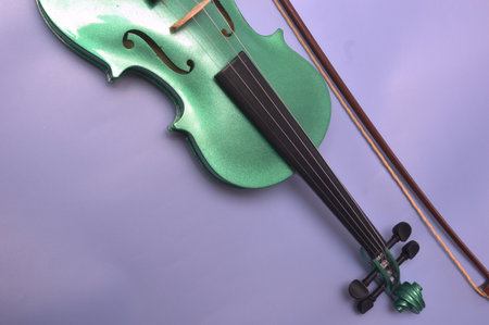 violin and bow on a purple background, closeup of photoの写真素材